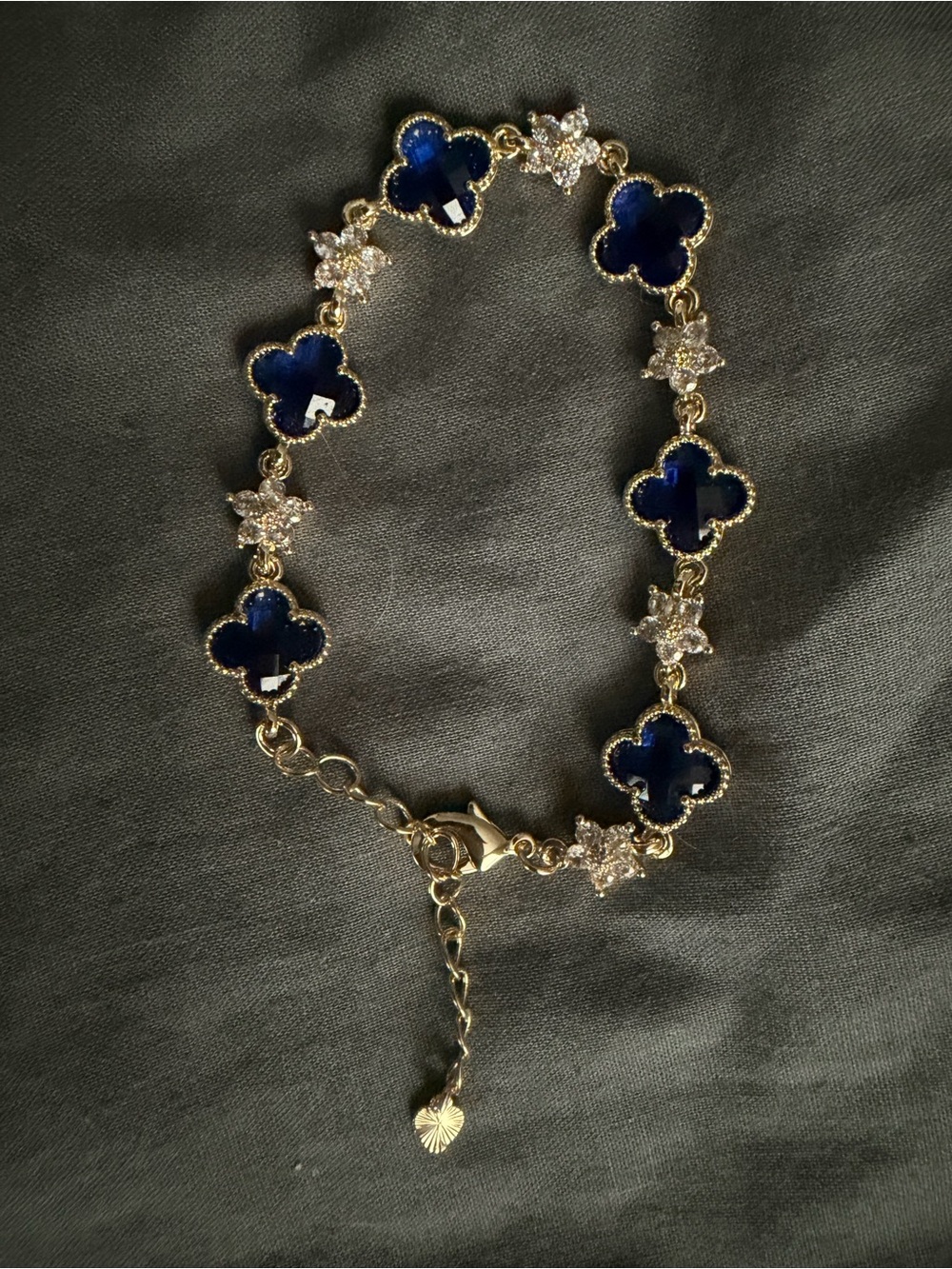 Gold Bracelet with Navy Blue Clover Motifs and Crystal Accents